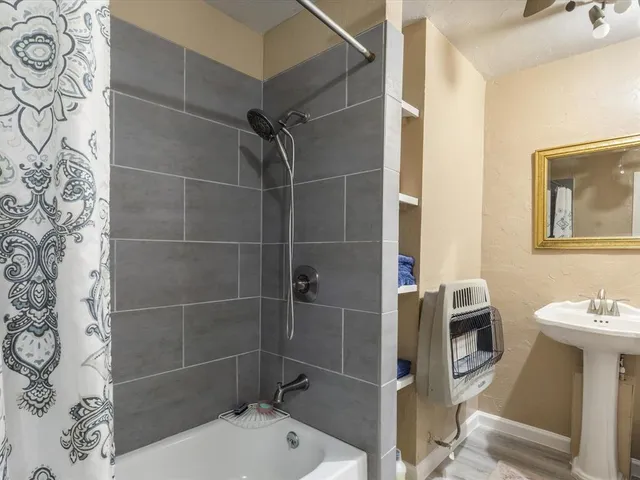 a bathroom with a sink toilet and shower