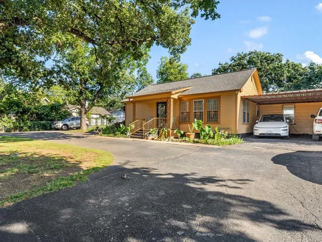 a front view of a house with a yard and a garage