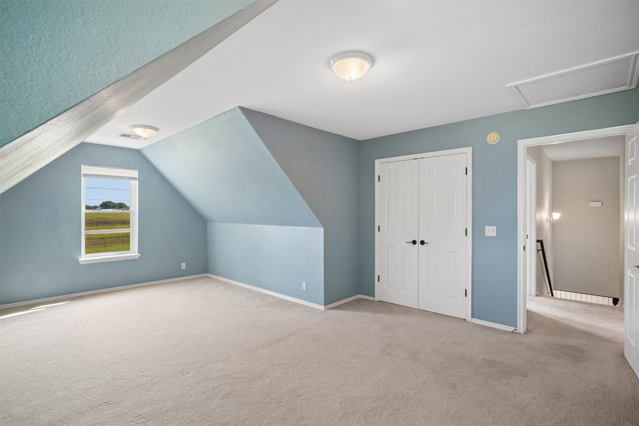 175 Alt 75 Mounds, OK 74047 - Photo 32 of 41 Carpeted room with sloped ceilings, a window with exterior scenery, and white double doors