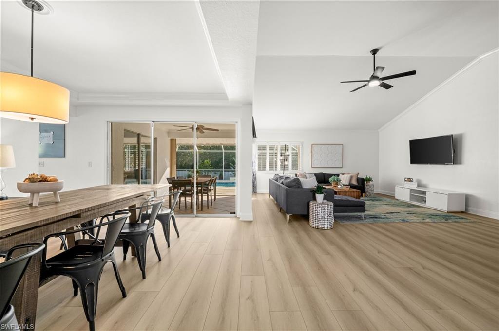 4 Colonial Drive Naples, FL 34112 - Photo 14 of 42 Living area with vaulted ceiling, light wood-style floors, a sunroom, ornamental molding, and ceiling fan