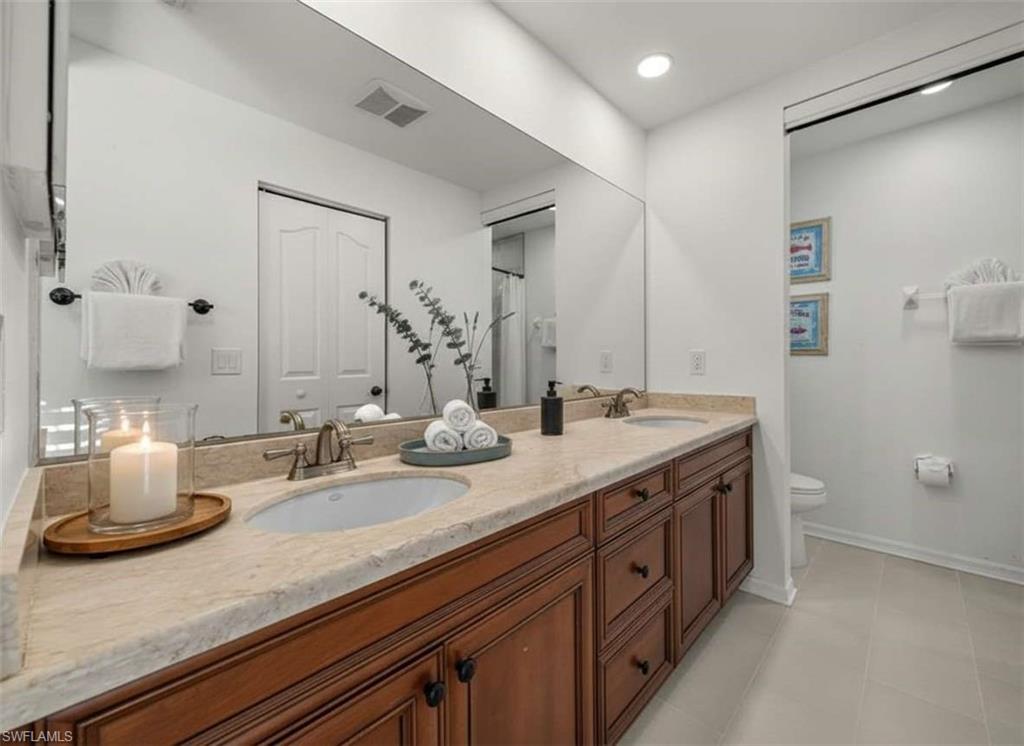 4 Colonial Drive Naples, FL 34112 - Photo 20 of 42 Bathroom with double vanity, curtained shower, light tile patterned floors, and recessed lighting