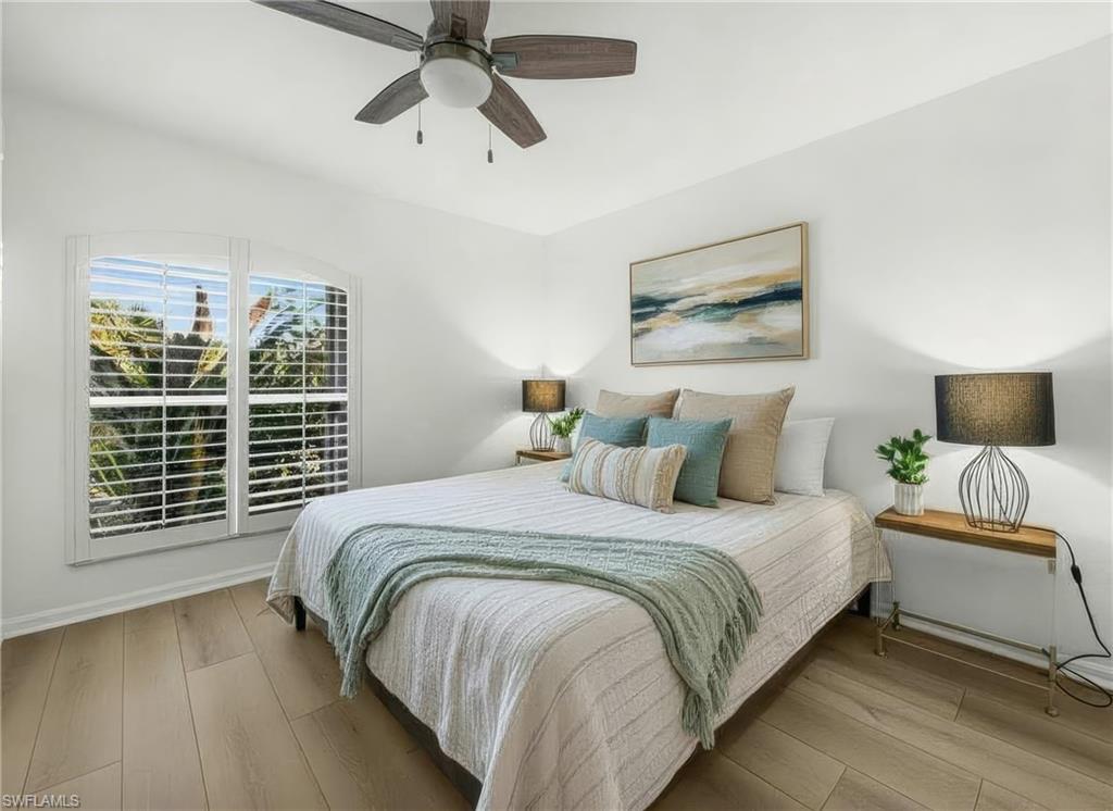 4 Colonial Drive Naples, FL 34112 - Photo 22 of 42 Bedroom with light wood finished floors and ceiling fan