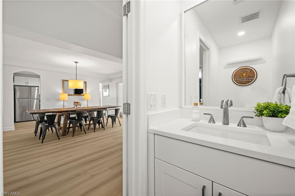 4 Colonial Drive Naples, FL 34112 - Photo 25 of 42 Bathroom featuring vanity and light wood-type flooring