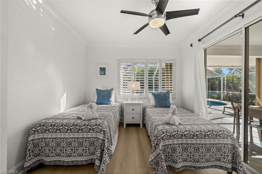 4 Colonial Drive Naples, FL 34112 - Photo 26 of 42 Bedroom with access to exterior, ornamental molding, hardwood / wood-style flooring, ceiling fan, and a sunroom