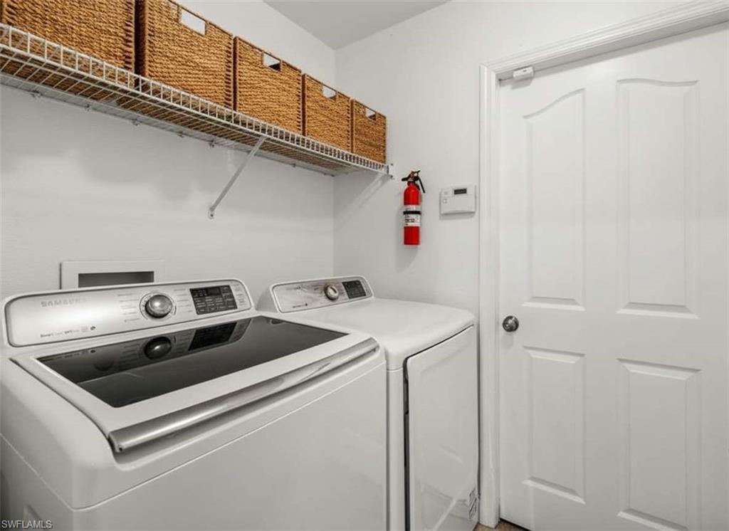 4 Colonial Drive Naples, FL 34112 - Photo 30 of 42 Laundry room with washing machine and clothes dryer