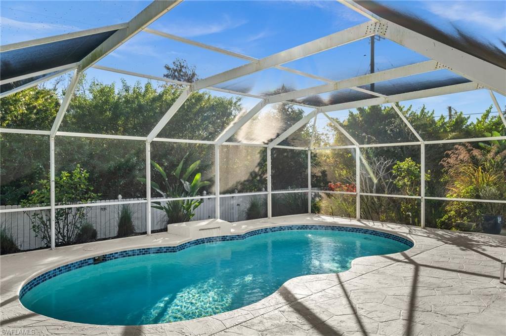 4 Colonial Drive Naples, FL 34112 - Photo 34 of 42 Outdoor pool with a lanai and a sunroom