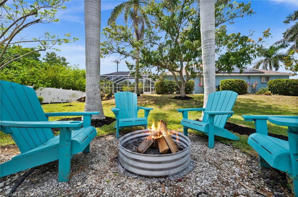 4 Colonial Drive Naples, FL 34112 - Photo 5 of 42 View of yard with a lanai and an outdoor fire pit