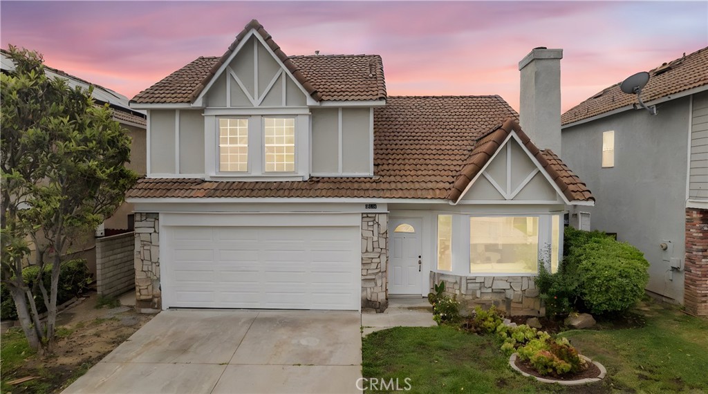 9757 Balaton Street Rancho Cucamonga, CA 91737 - Photo 1 of 1 a front view of a house with garden