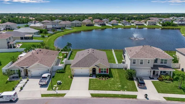 an aerial view of houses with yard