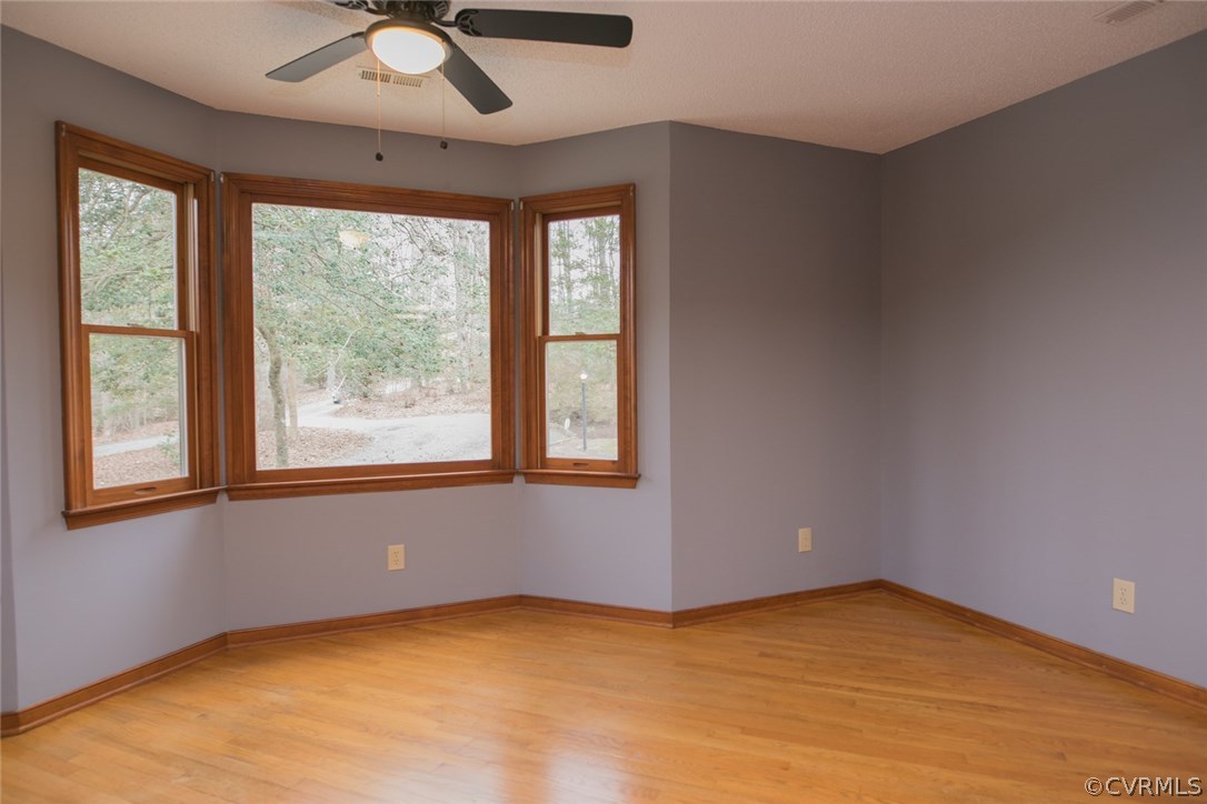 4002 Fraley Court Mechanicsville, VA 23111 - Photo 15 of 49 an empty room with a window and a ceiling fan