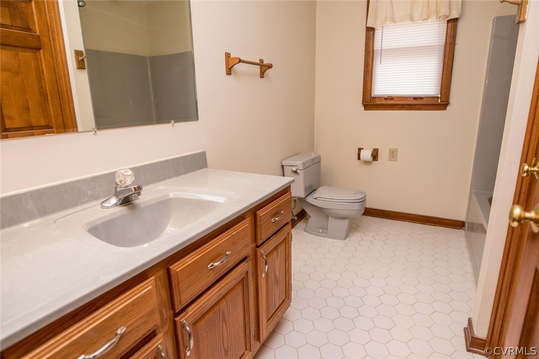 4002 Fraley Court Mechanicsville, VA 23111 - Photo 28 of 49 a bathroom with a sink a toilet and mirror