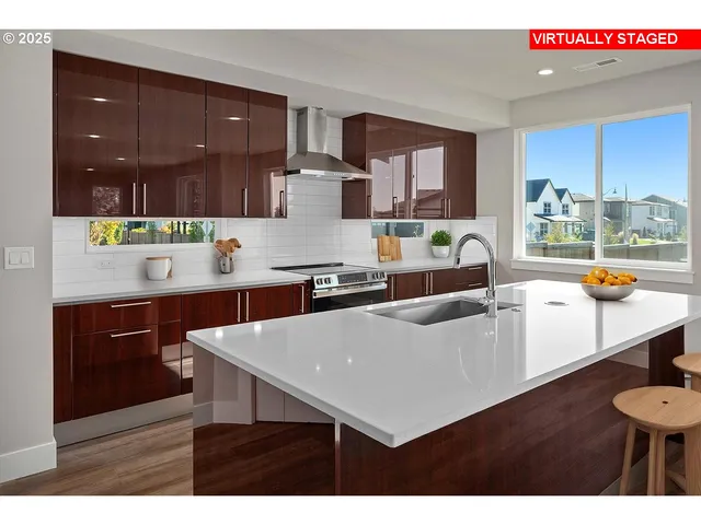 a living room with stainless steel appliances kitchen island granite countertop a table chairs and a refrigerator