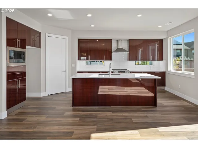a view of kitchen with stainless steel appliances granite countertop a sink and a stove