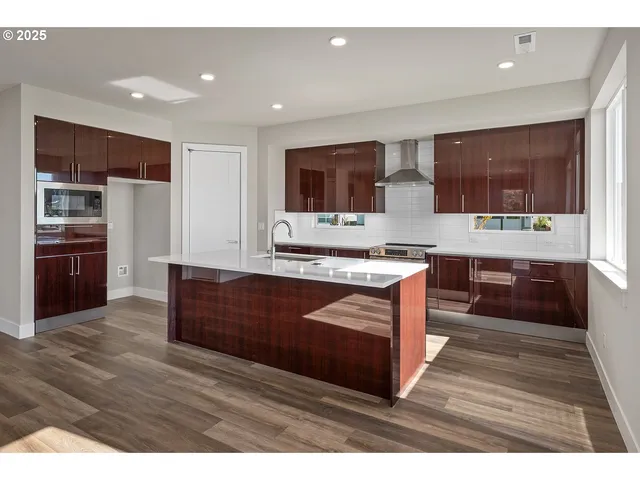 a kitchen with stainless steel appliances granite countertop a stove and a sink