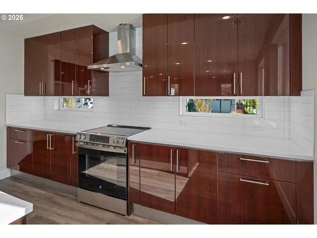 a kitchen with stainless steel appliances kitchen island granite countertop a stove a sink and a microwave