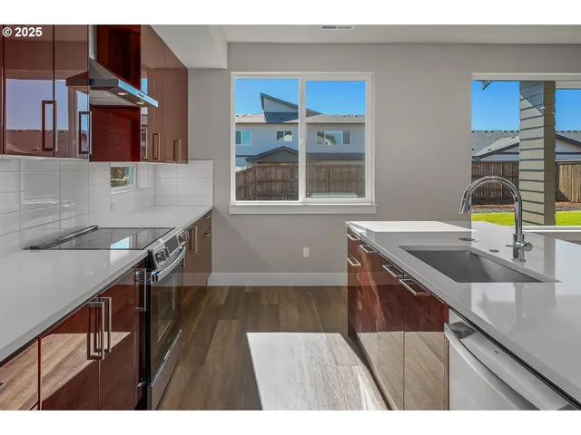 a kitchen with a sink cabinets and a wooden floor