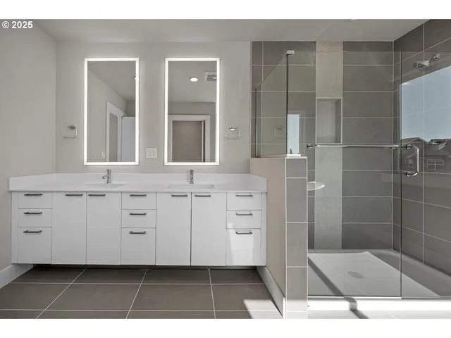 a bathroom with a shower a sink and a mirror