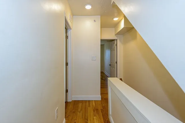 a view of hallway with wooden floor