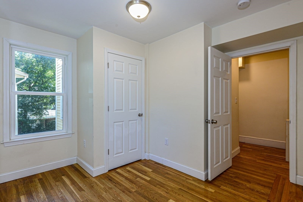2 Mechanic Street, Unit 1 Newton, MA 02464 - Photo 9 of 14 a view of an empty room with wooden floor and a window