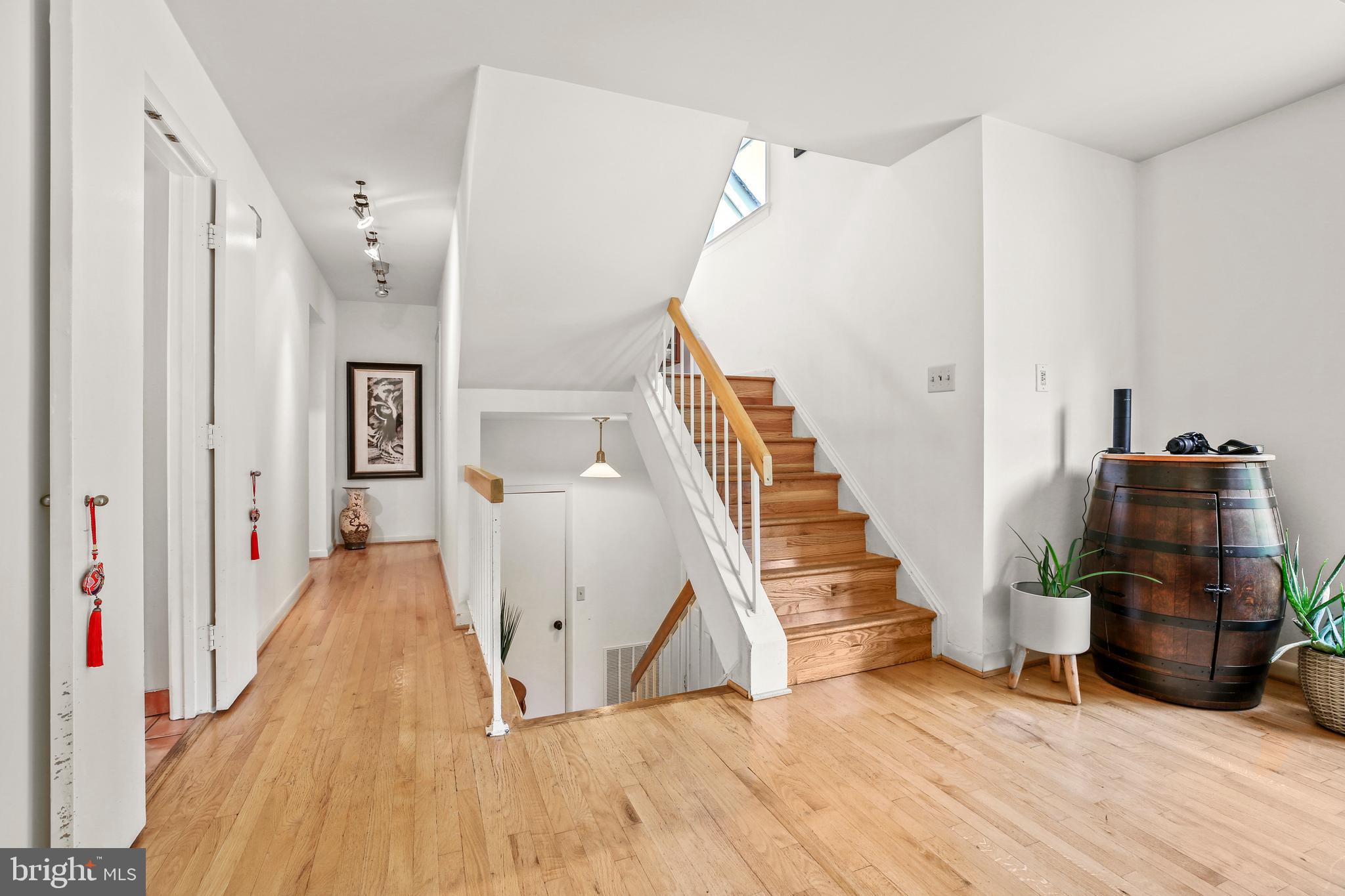 11212 Angus Place Potomac, MD 20854 - Photo 18 of 42 a view of a livingroom with wooden floor and stairs