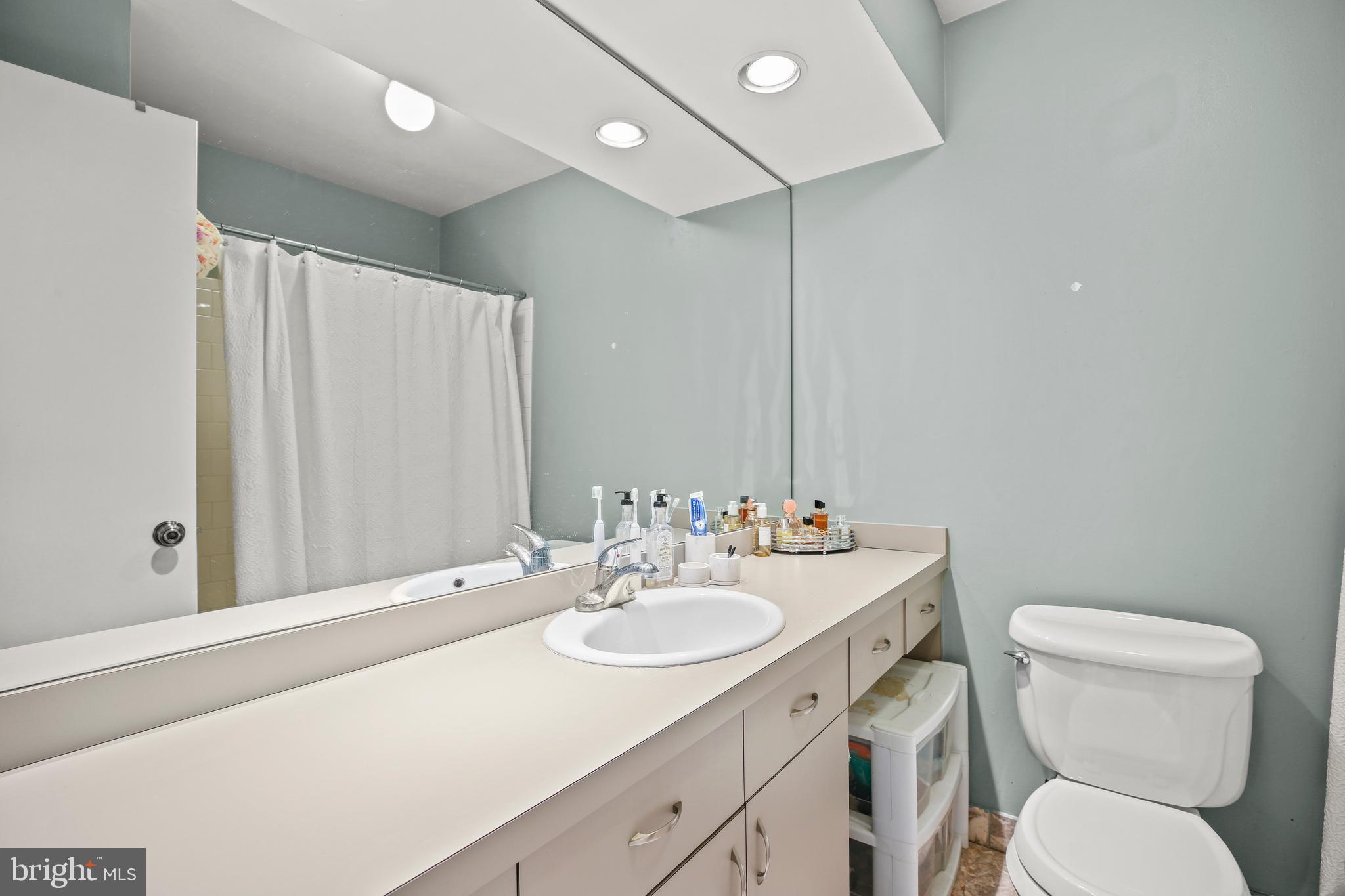 11212 Angus Place Potomac, MD 20854 - Photo 21 of 42 a bathroom with a sink toilet and mirror