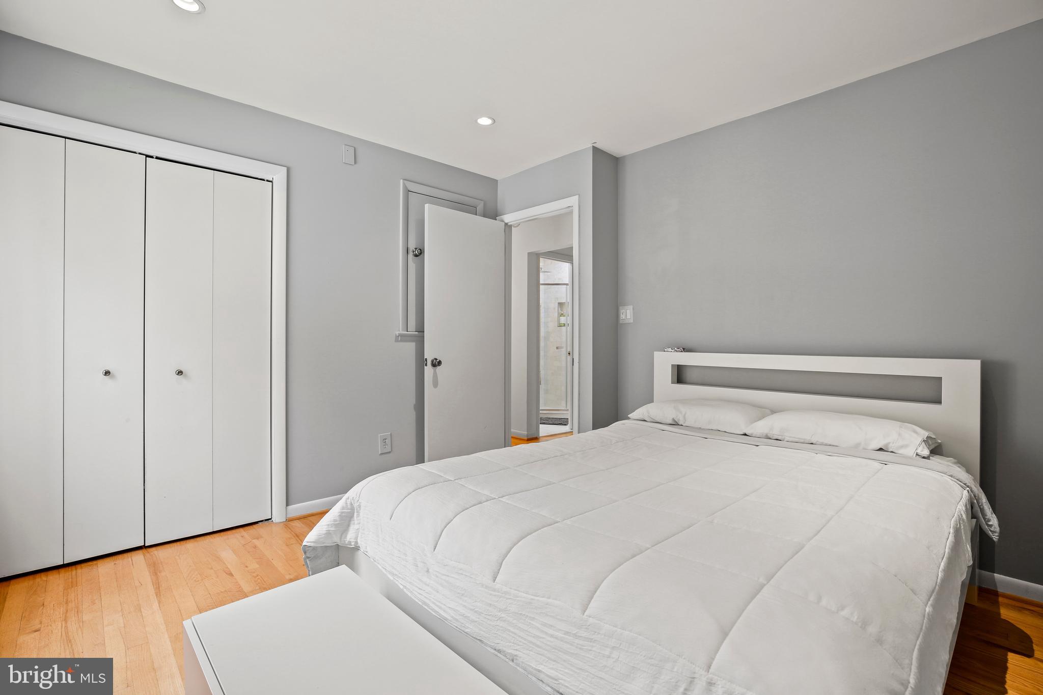 11212 Angus Place Potomac, MD 20854 - Photo 23 of 42 a bedroom with a large bed and wooden floor