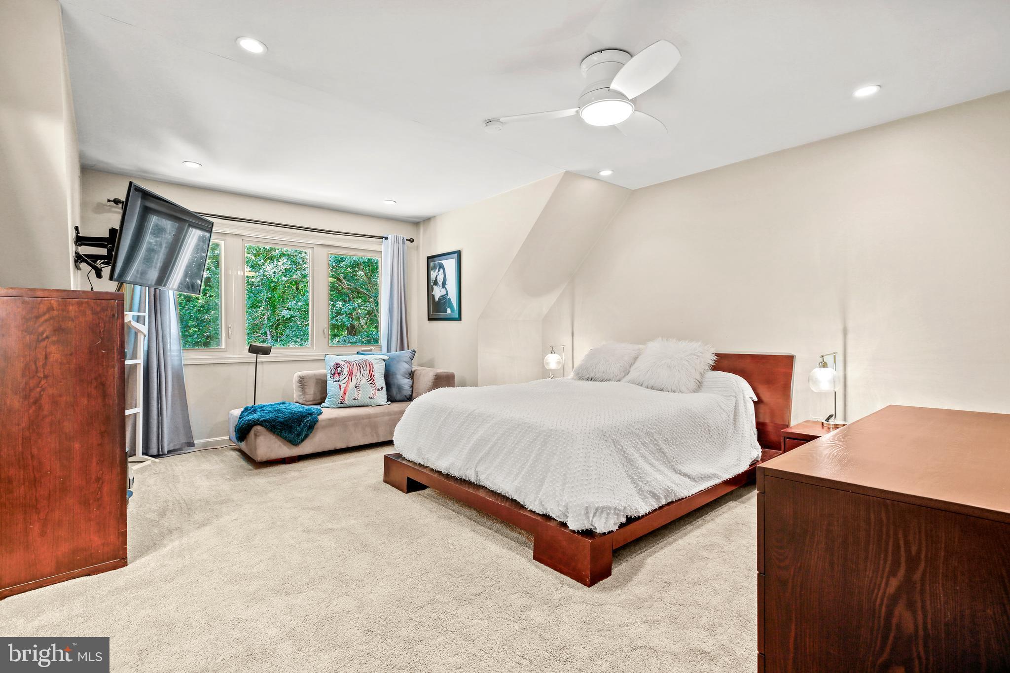 11212 Angus Place Potomac, MD 20854 - Photo 30 of 42 a spacious bedroom with a bed and a large window