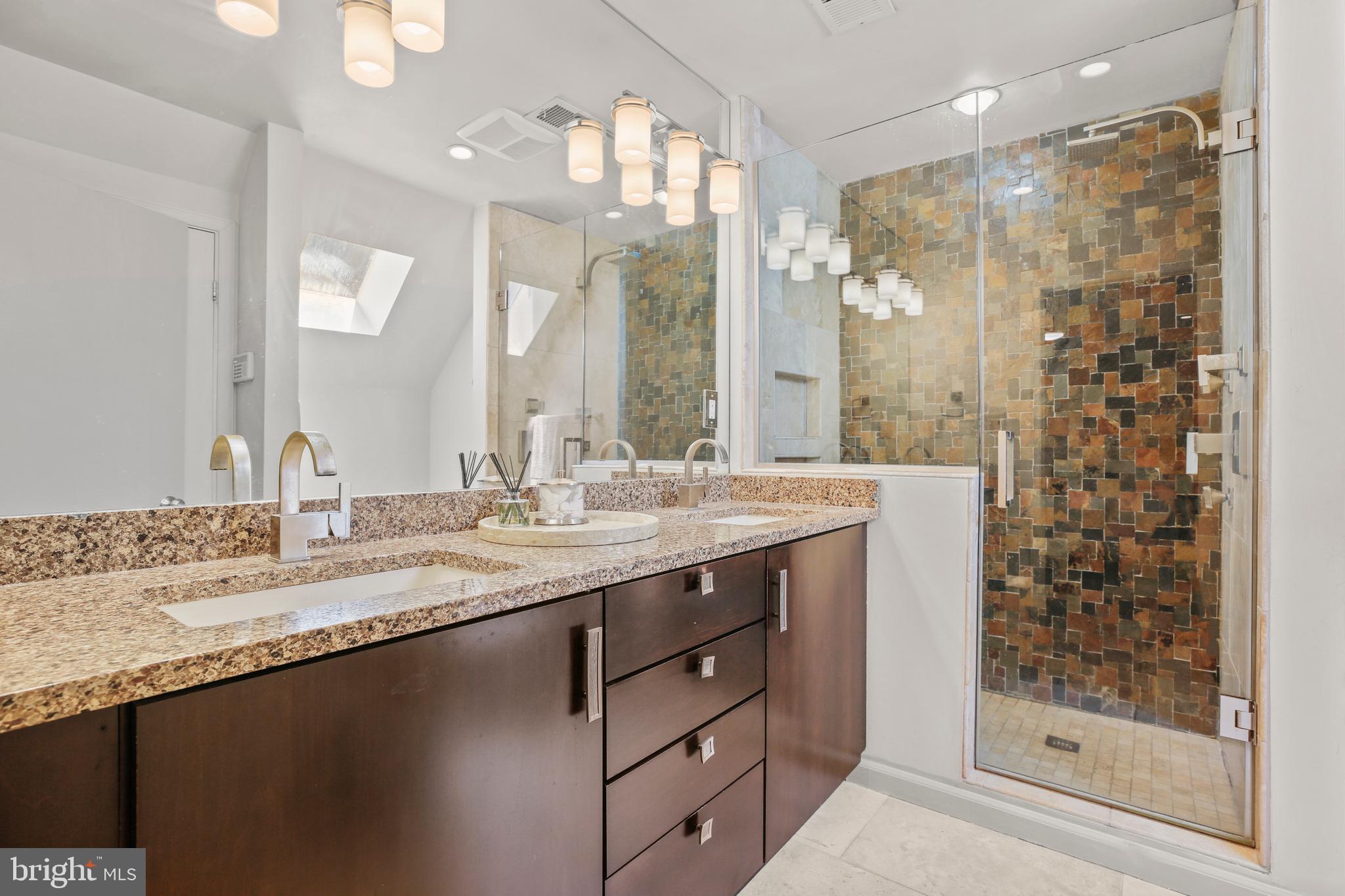 11212 Angus Place Potomac, MD 20854 - Photo 32 of 42 a bathroom with a granite countertop sink a mirror a shower and a bathtub
