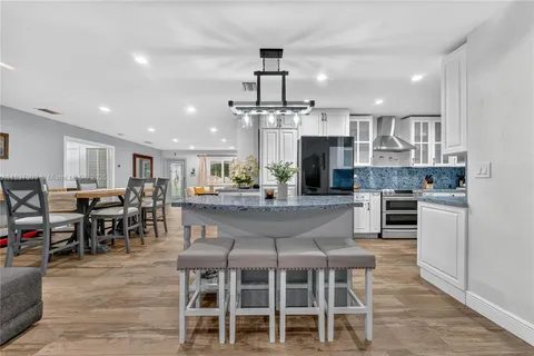 a large kitchen with a table and chairs