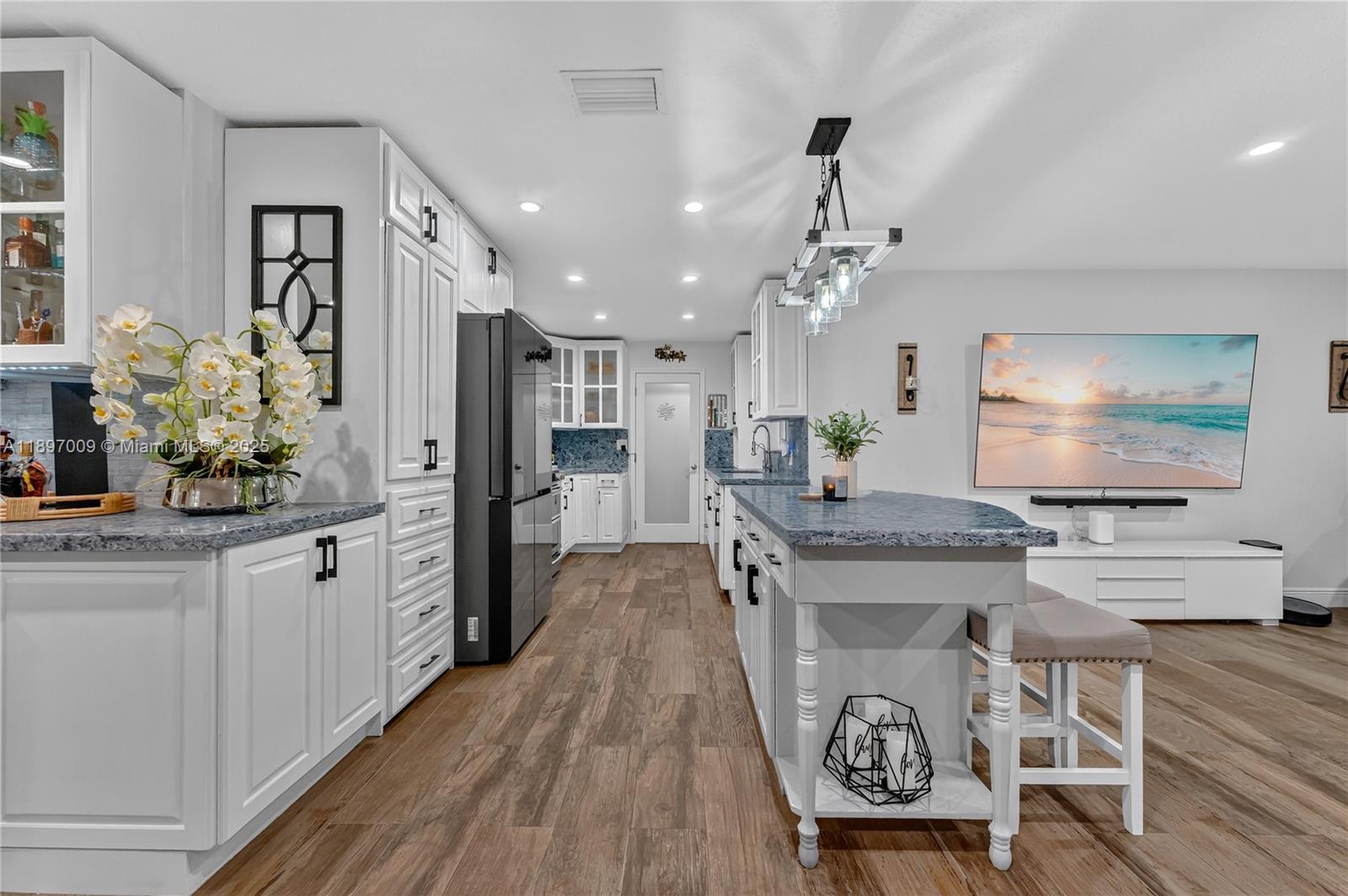 32020 Southwest 199th Avenue Homestead, FL 33030 - Photo 17 of 43 a large kitchen with kitchen island a counter top space a sink stainless steel appliances and cabinets