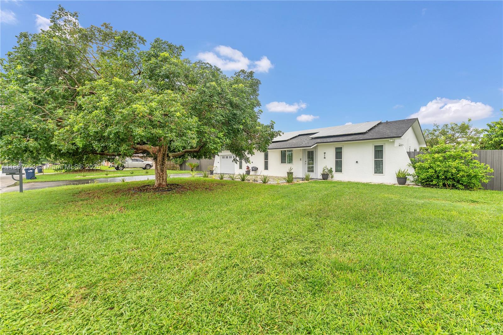 32020 Southwest 199th Avenue Homestead, FL 33030 - Photo 2 of 43 a front view of house with yard and trees
