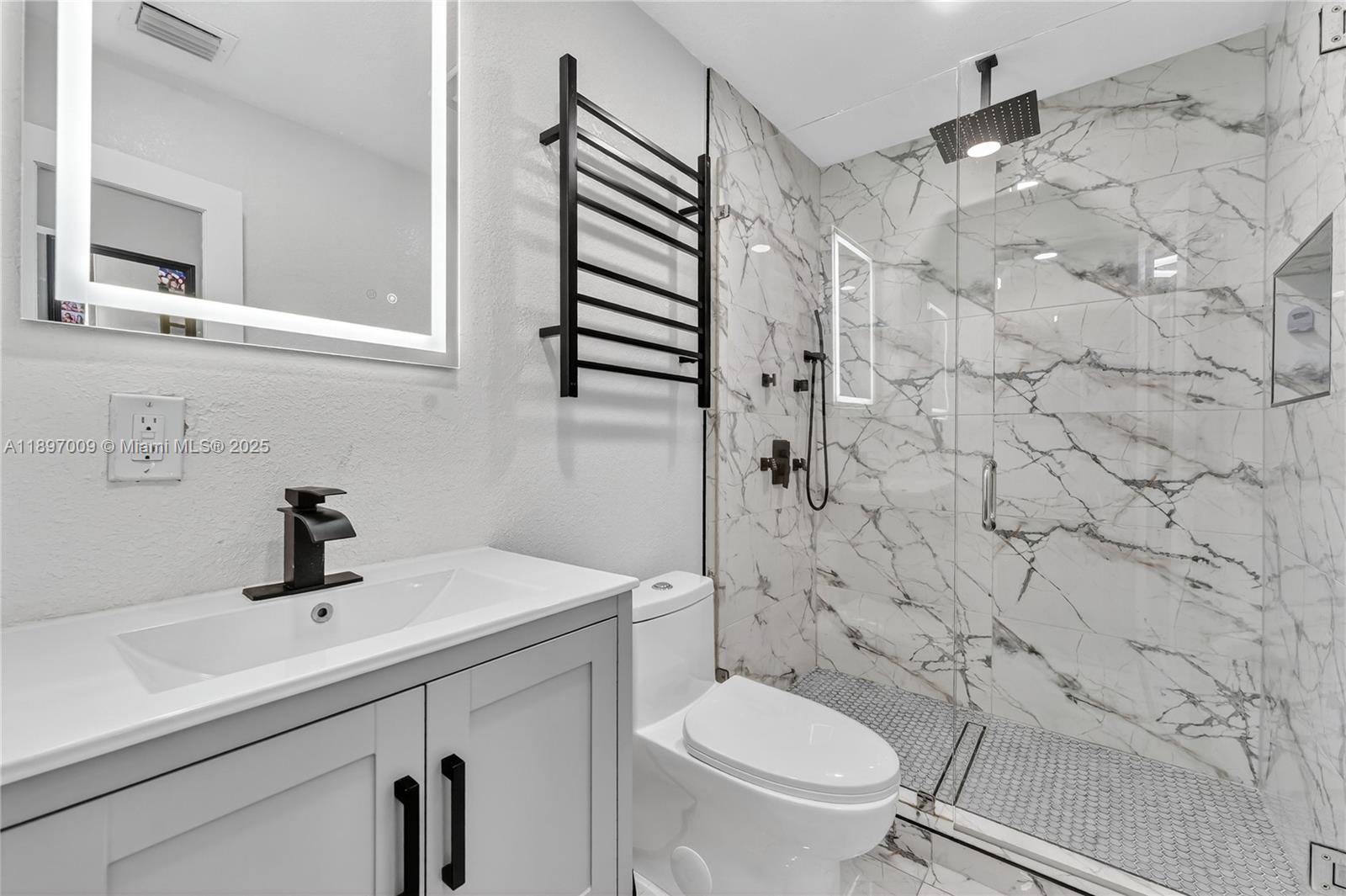 32020 Southwest 199th Avenue Homestead, FL 33030 - Photo 21 of 43 a bathroom with a sink a toilet and shower curtain