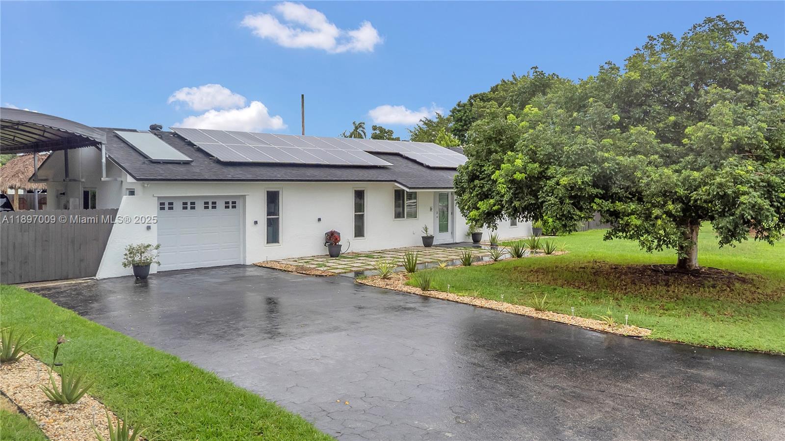 32020 Southwest 199th Avenue Homestead, FL 33030 - Photo 22 of 43 a view of a house with backyard and trees