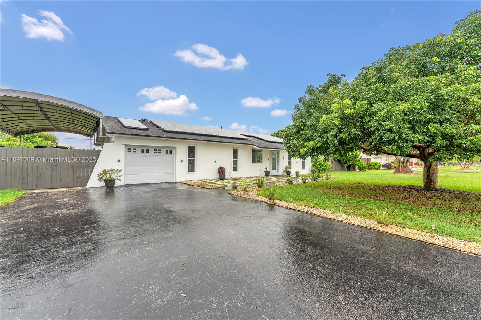 32020 Southwest 199th Avenue Homestead, FL 33030 - Photo 28 of 43 a view of a house with a yard and a large tree