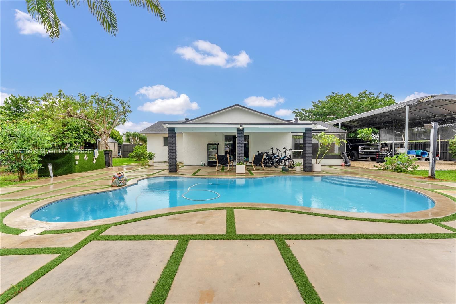 32020 Southwest 199th Avenue Homestead, FL 33030 - Photo 29 of 43 a view of a swimming pool with a patio