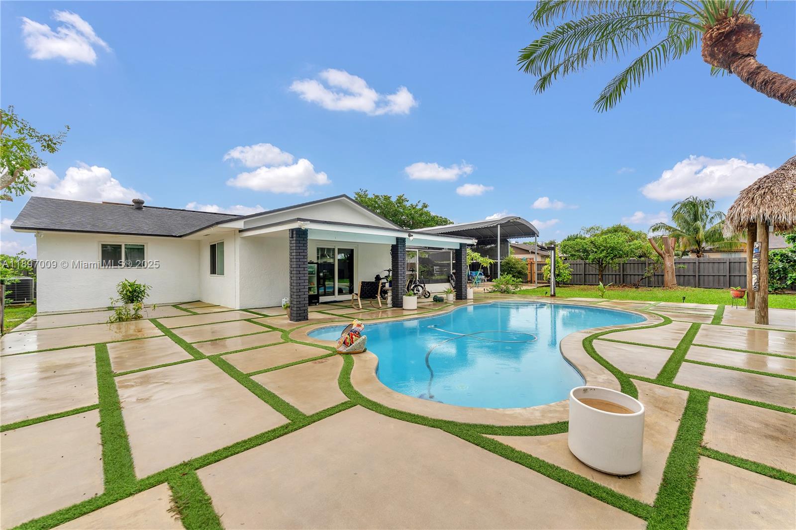 32020 Southwest 199th Avenue Homestead, FL 33030 - Photo 30 of 43 a view of a swimming pool with a patio