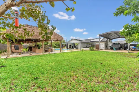 a view of an house with backyard porch and sitting area