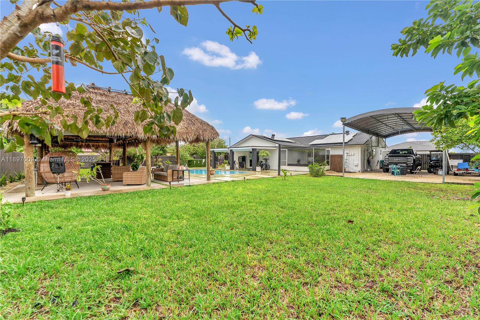 32020 Southwest 199th Avenue Homestead, FL 33030 - Photo 36 of 43 a view of an house with backyard porch and sitting area