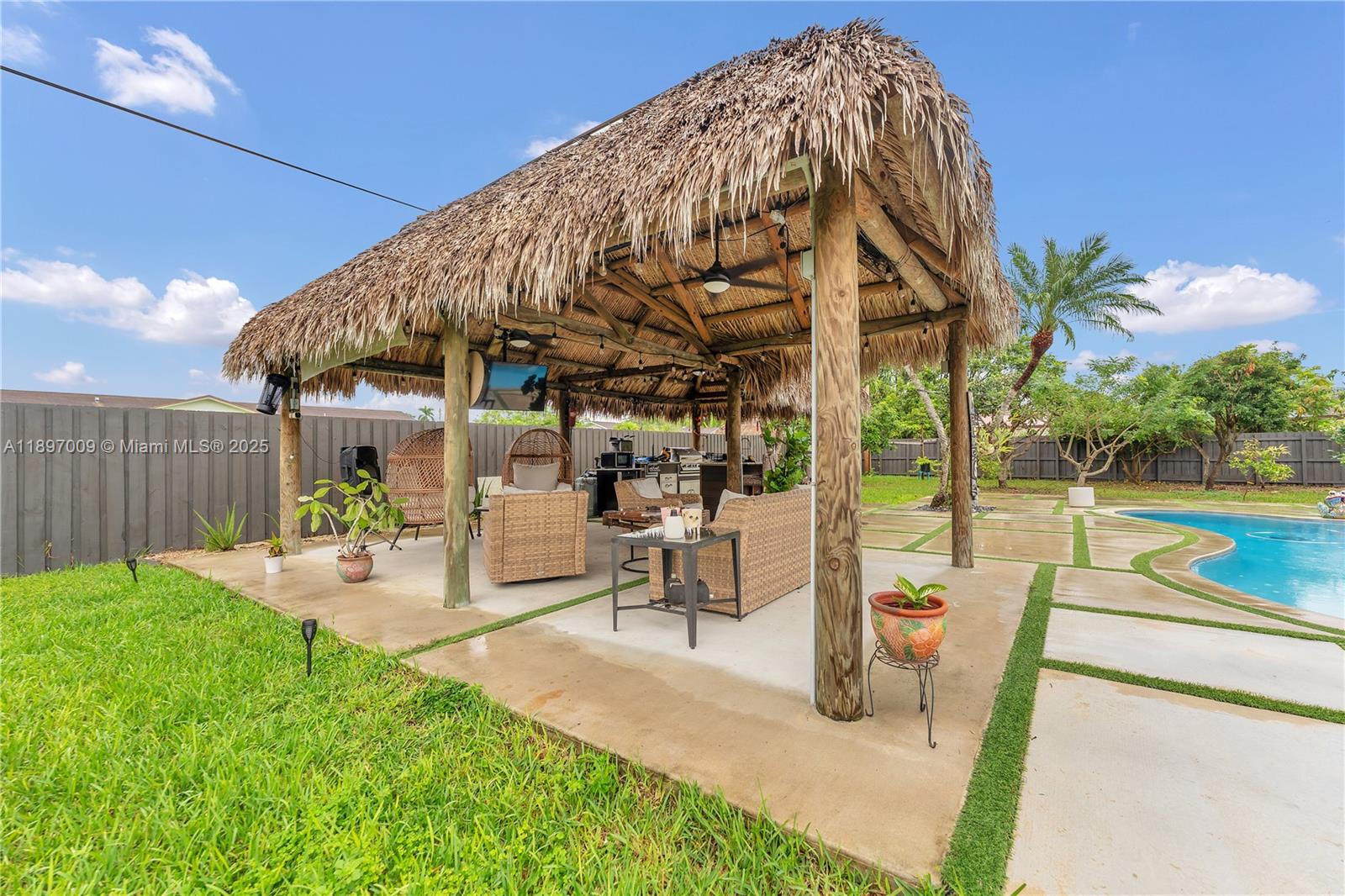 32020 Southwest 199th Avenue Homestead, FL 33030 - Photo 37 of 43 a view of a swimming pool with a patio