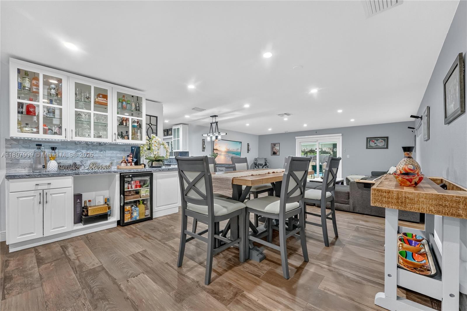 32020 Southwest 199th Avenue Homestead, FL 33030 - Photo 6 of 43 a kitchen with stainless steel appliances granite countertop a table and chairs with wooden floor