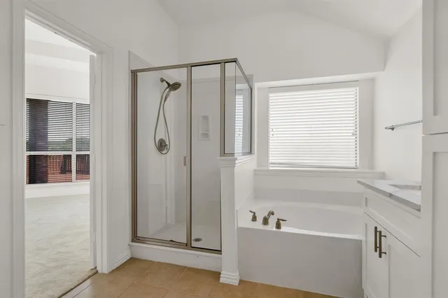 a bathroom with a bathtub and a shower