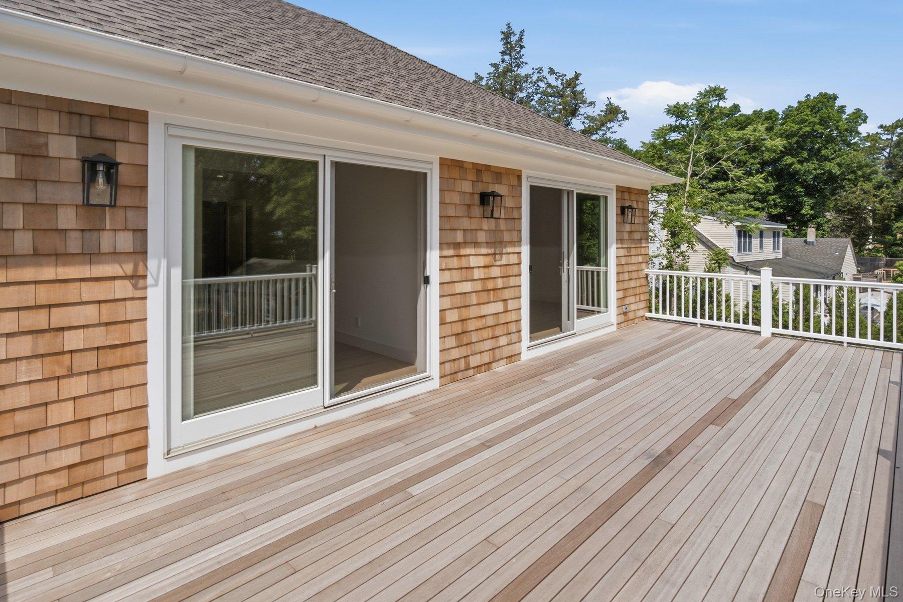 12 Red Creek Road Hampton Bays, NY 11946 - Photo 28 of 38 Sliders/Balcony/Deck off Primary and Ensuite Guest Bedroom