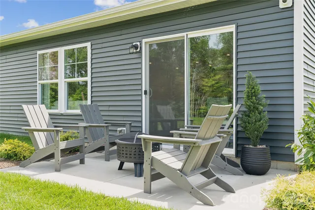 a view of a patio with table and chairs and potted plants