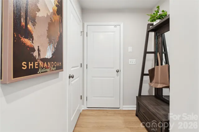 a view of hallway with stairs and wooden floor