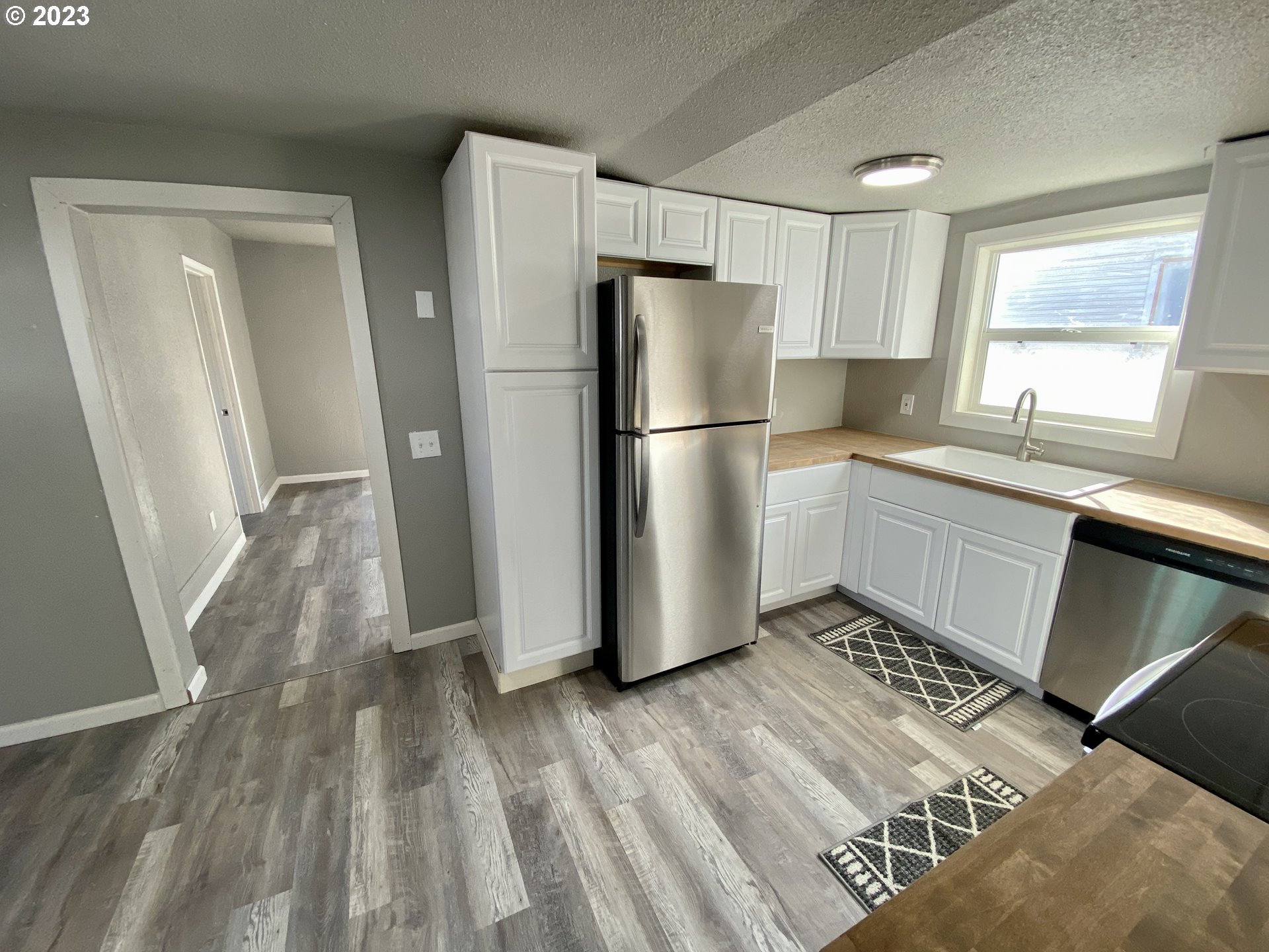 417 East Court Street Goldendale, WA 98620 - Photo 6 of 19 a kitchen with a refrigerator a sink and dishwasher
