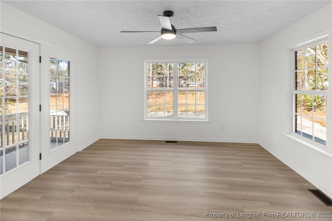 3638 Golfview Road Hope Mills, NC 28348 - Photo 18 of 35 a view of an empty room with a window and wooden floor