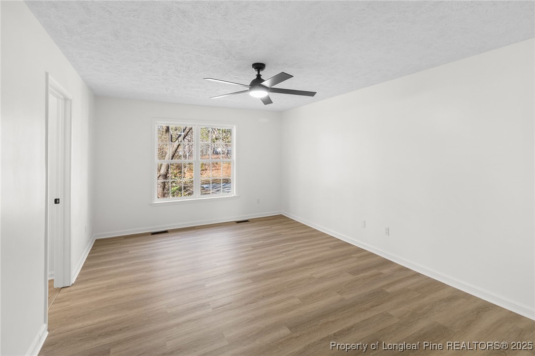 3638 Golfview Road Hope Mills, NC 28348 - Photo 26 of 35 wooden floor in an empty room with a window