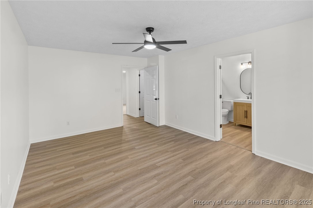 3638 Golfview Road Hope Mills, NC 28348 - Photo 27 of 35 a view of empty room with wooden floor and fan