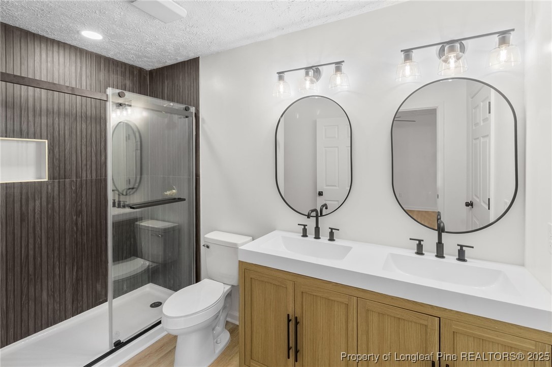 3638 Golfview Road Hope Mills, NC 28348 - Photo 29 of 35 a bathroom with 2 sink toilet and a mirror