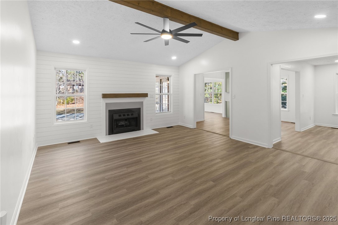 3638 Golfview Road Hope Mills, NC 28348 - Photo 7 of 35 an empty room with windows and a fireplace